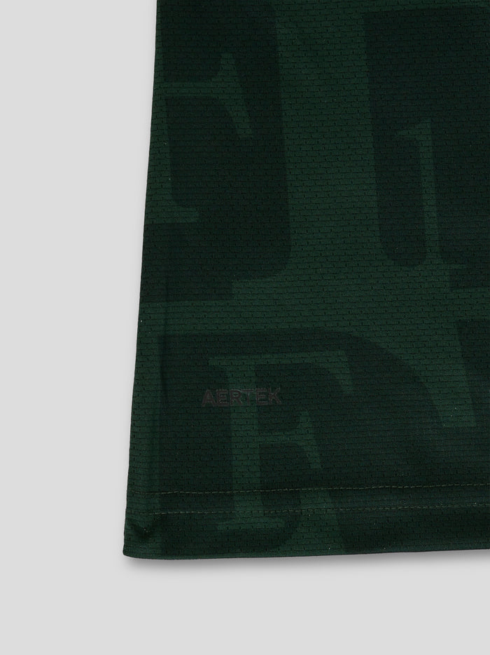Back lower section of dark green Feyenoord jersey with an all over pattern and a large Media Markt sponsor across the hem