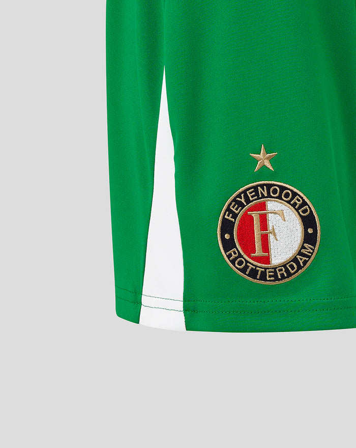 Close-up of the Feyenoord badge embroidery on green women's shorts with a white side panel