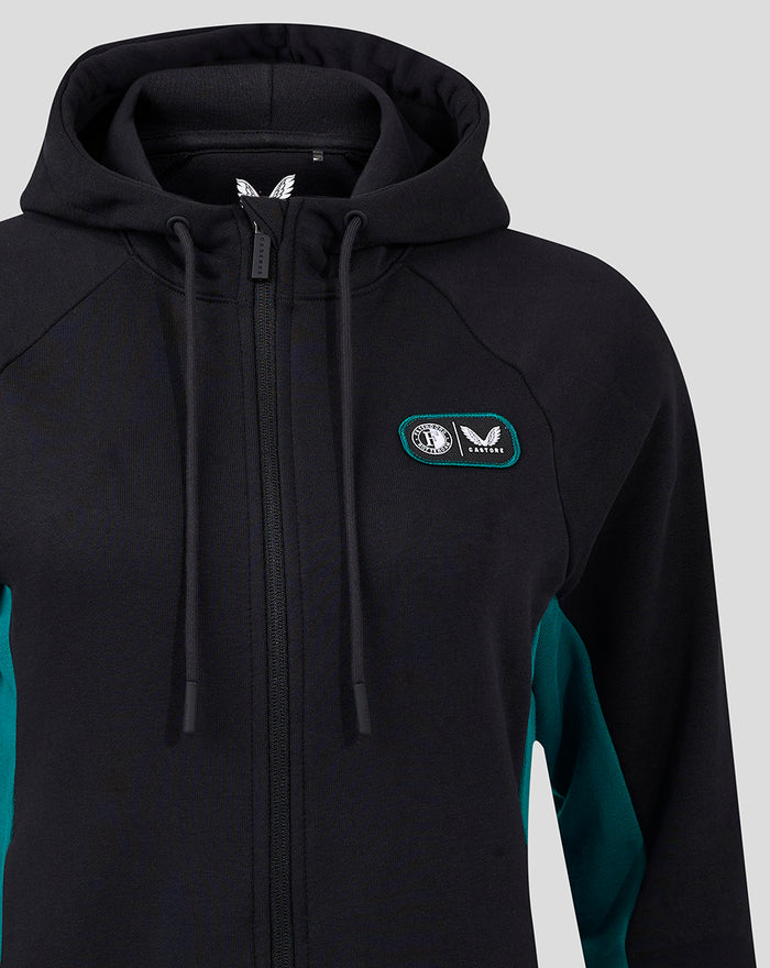 Close up of black hooded fleece jacket with zipper and teal chest patch featuring Feyenoord Castore logo