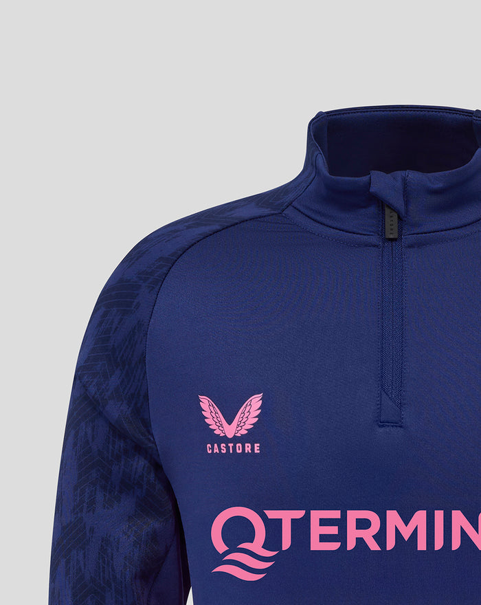 Close-up of blue Castore training top with pink logo on the chest and large pink lettering across the front