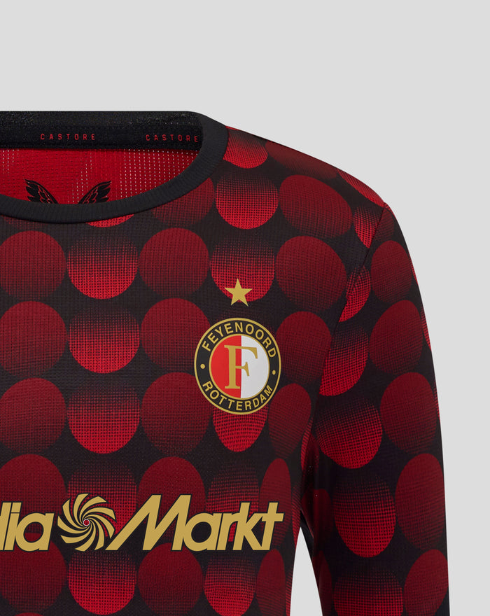 Close up of the jersey collar showing Castore branding on a black band and red dot fabric