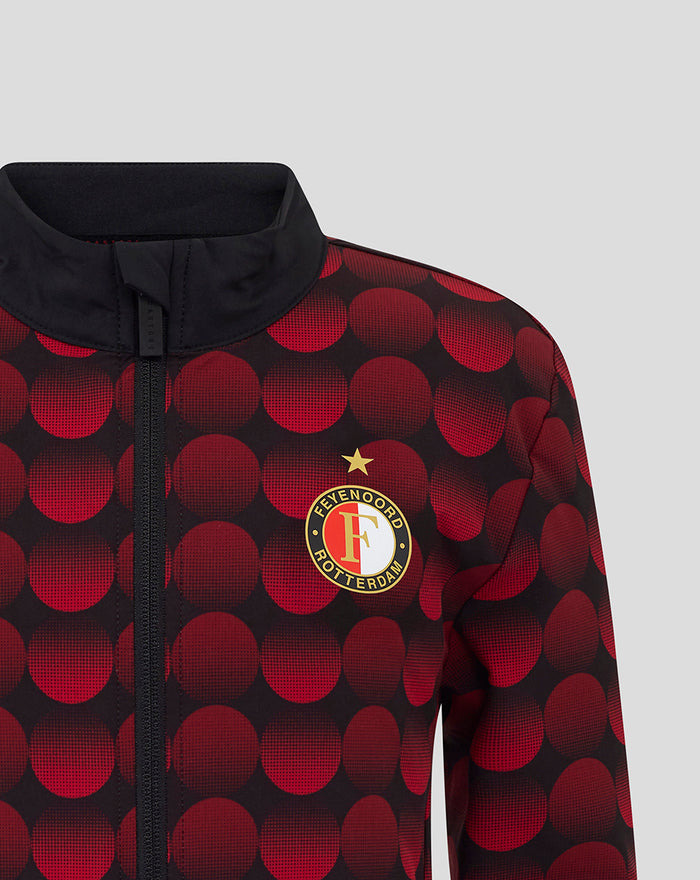 Front view of the jacket with a full-length zipper and crest on the chest against a red circular print