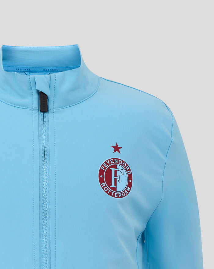 Close up of the jacket's upper chest and collar in light blue showing the Castore label and partial Feyenoord crest.