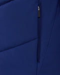 Close up of blue fabric and vertical zipper on the jacket showing textured material and stitching