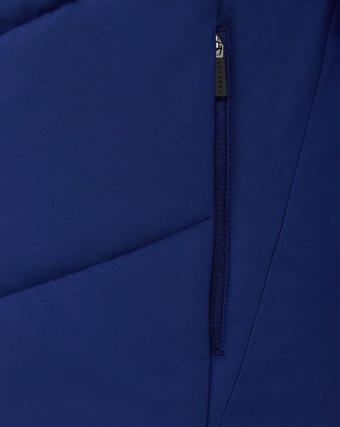 Close up of blue fabric and vertical zipper on the jacket showing textured material and stitching