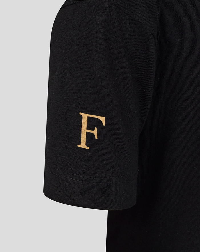 Close-up of a black junior T-shirt sleeve with a gold letter F