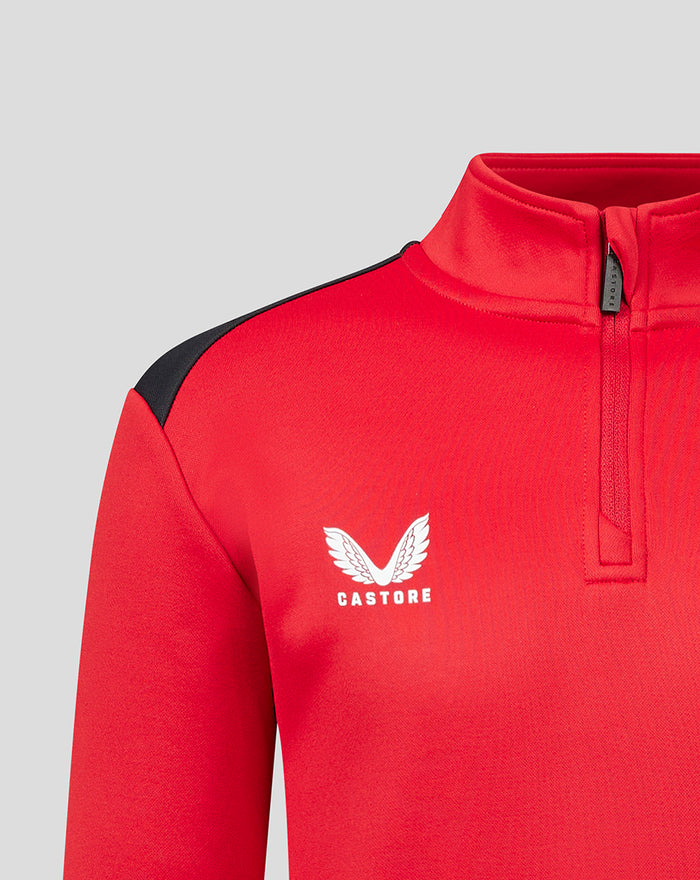 Close up of red fleece training top with black shoulder panel and Castore branding on the chest