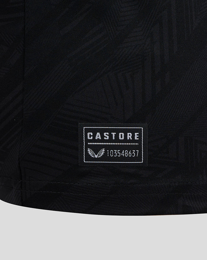 Castore label patch with serial number on the lower hem of a black Feyenoord jersey