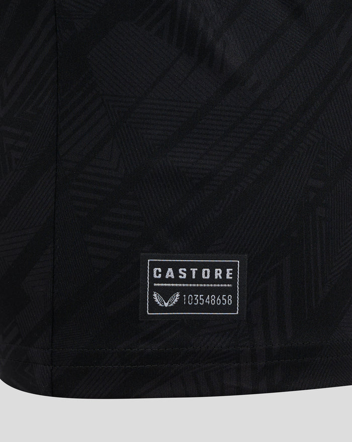 Close up of dark textured fabric with a Castore label on a Feyenoord shirt