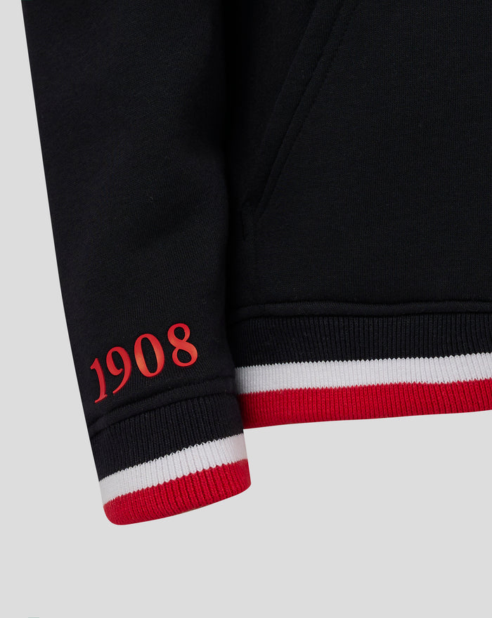 Close up of the black Feyenoord Junior Hoody sleeve showing red 1908 numerals and white red striped cuff