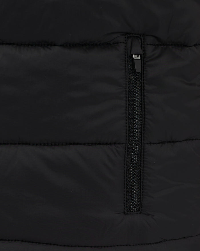 Close-up of a black padded gilet highlighting the vertical zipper and quilted fabric