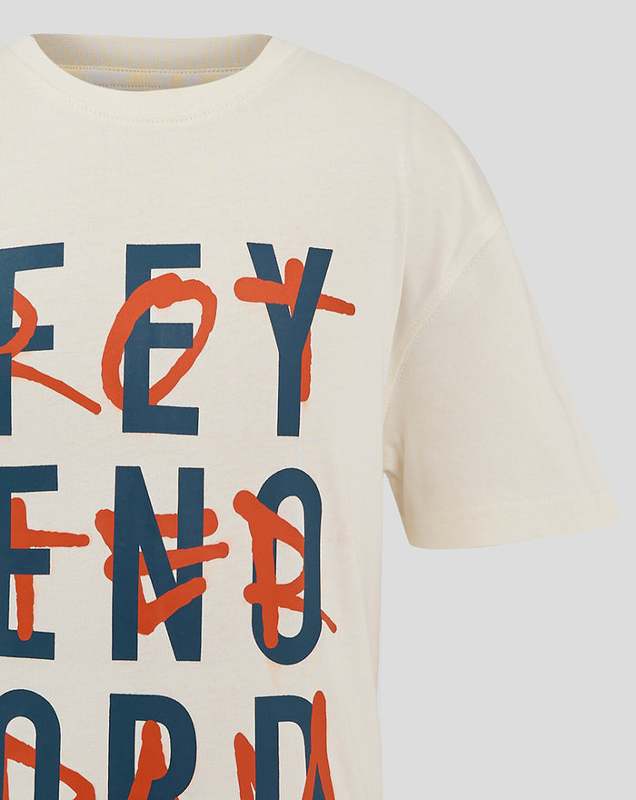 Close up of a white junior Feyenoord T shirt showing large navy letters with orange graffiti marks across them