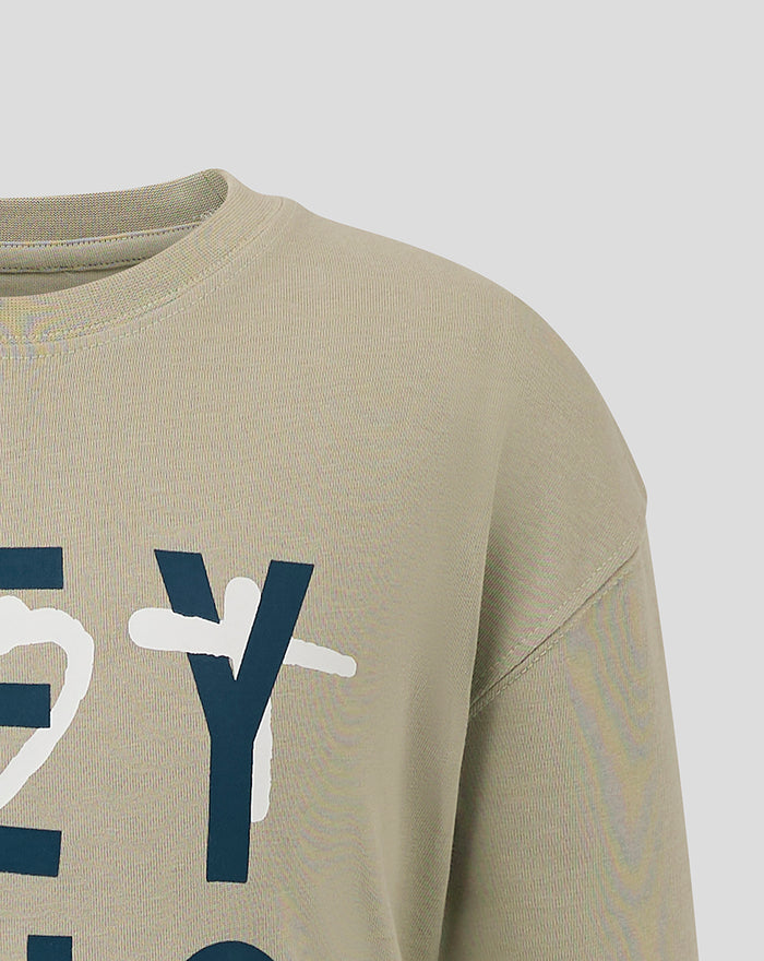 Close up of the front neckline and graphic on a beige Feyenoord Contemporary Junior T shirt