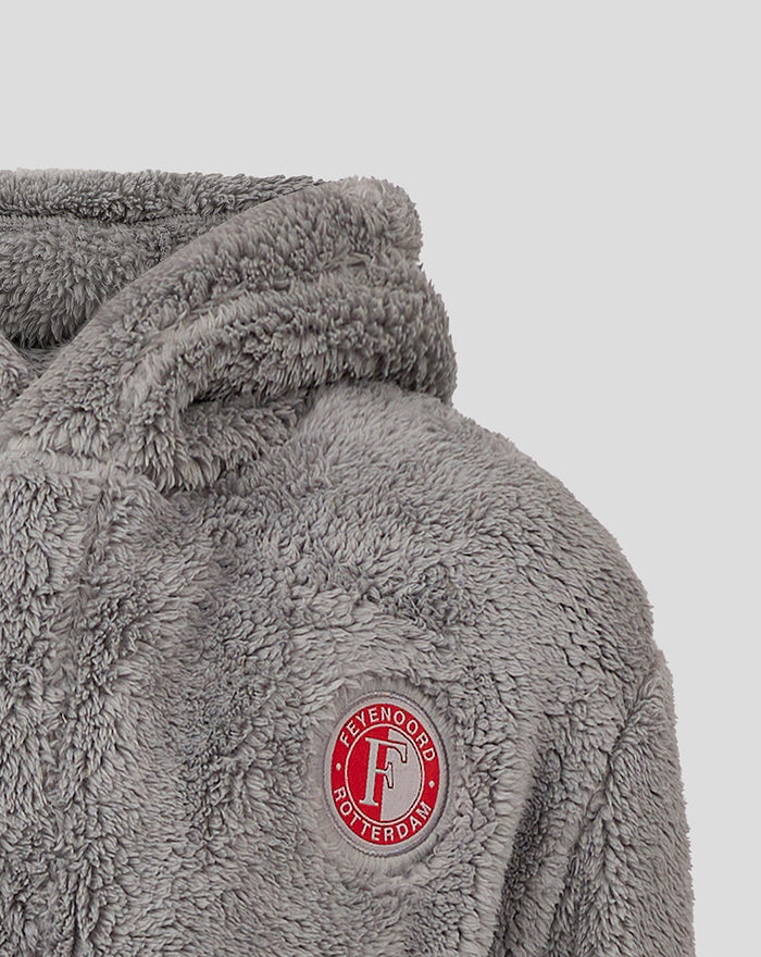 Close-up of Feyenoord circular logo patch on grey fluffy bathrobe.