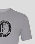 Close up of the upper front displaying the black circular Feyenoord emblem on the grey T shirt.
