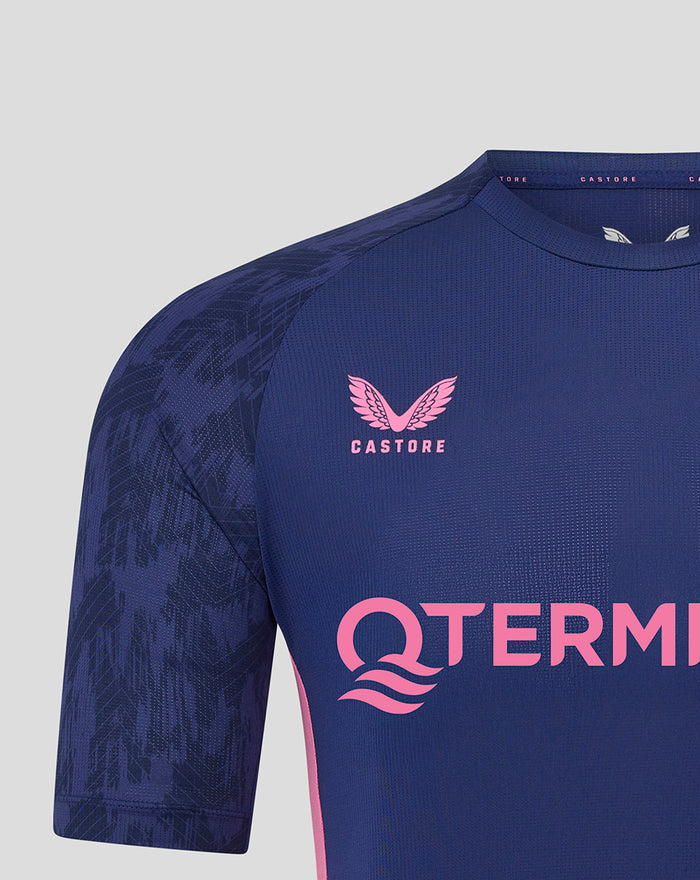 Close-up front of navy Feyenoord training shirt featuring pink branding across the chest and crest.