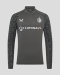 Front view of a dark gray Feyenoord Castore training midlayer top with quarter zip patterned sleeves and chest logos.