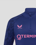 Close-up of blue Feyenoord Spelers Training Midlayer Top with Castore logo on the right chest and Feyenoord crest on the left chest and a pink graphic across the front.