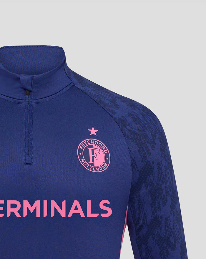Close-up of blue Feyenoord training midlayer chest showing left crest and TERMINALS wordmark.