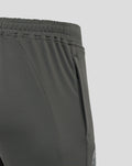 Close-up of side pocket and seam on the thigh of the gray training pants with branding.