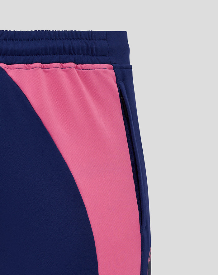 Side view of navy training pants with pink contrast panel and elastic waistband.