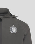 Close-up of Feyenoord badge on the chest of the gray training jacket with hood.