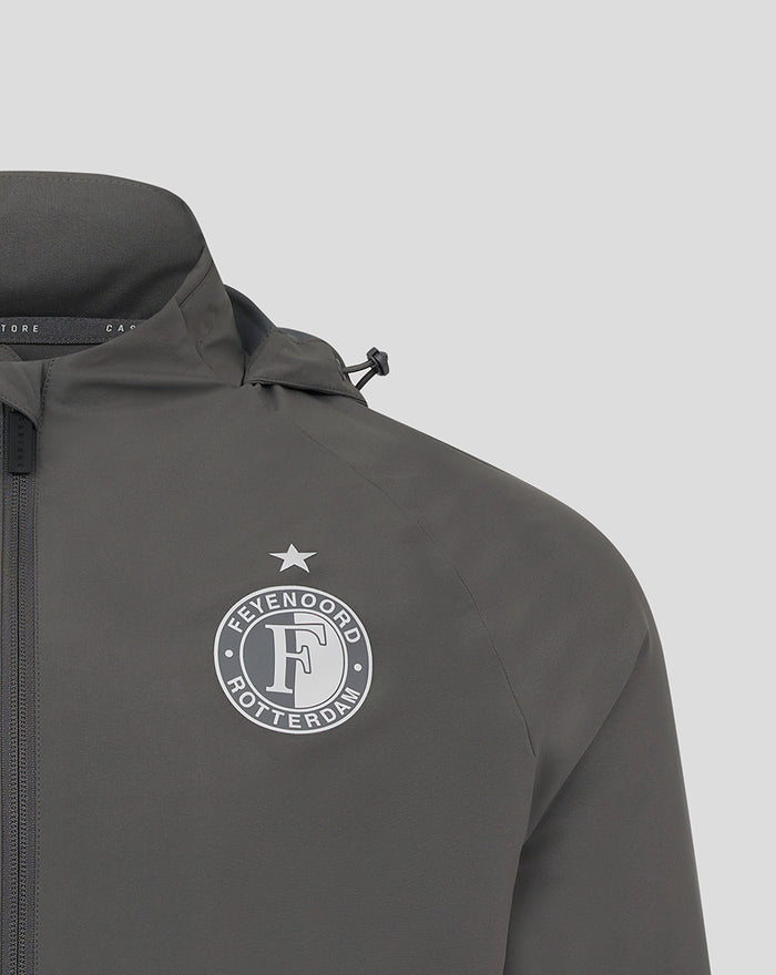 Close-up of Feyenoord badge on the chest of the gray training jacket with hood.