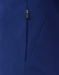 Close-up of blue training jacket zipper with Castore branded pull and diagonal seam