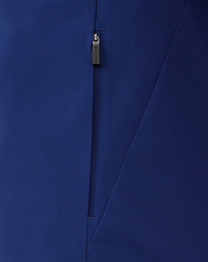 Close-up of blue training jacket zipper with Castore branded pull and diagonal seam