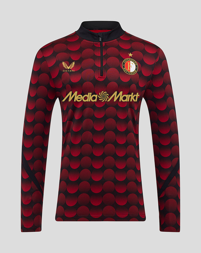 Feyenoord home matchday midlayer top 2025-26 front view featuring red circular pattern with gold Castore logo and MediaMarkt sponsor.