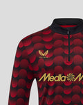 Close-up of Feyenoord home Matchday Midlayer Top with red circular pattern, left chest crest and Castore logo beside Media Markt across the chest
