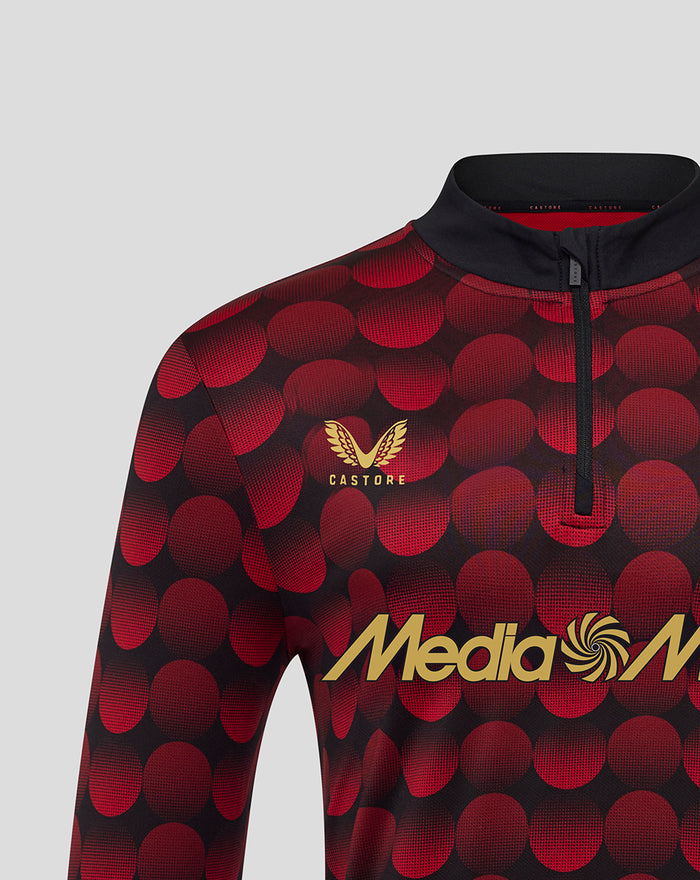 Close-up of Feyenoord home Matchday Midlayer Top with red circular pattern, left chest crest and Castore logo beside Media Markt across the chest