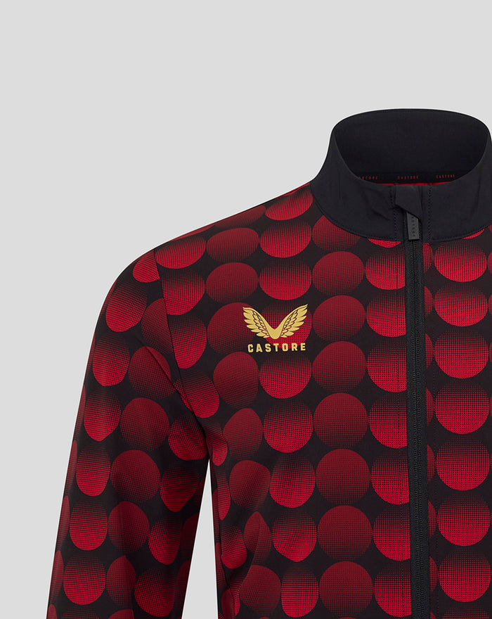Close-up of Feyenoord home jacket 2025-2026 with red circular pattern on black fabric and a gold Castore logo on the chest.
