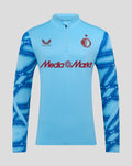 Front view of light blue Feyenoord Derde Matchday Midlayer Top with patterned dark blue sleeves and MediaMarkt logo across chest.