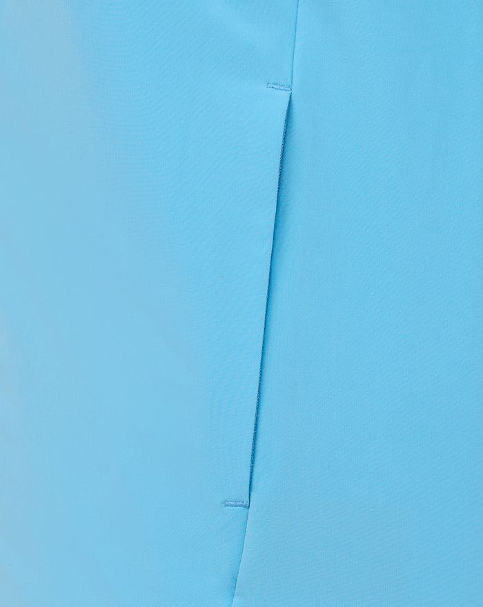 Close-up of light blue fabric with a vertical seam from a lightweight athletic jacket
