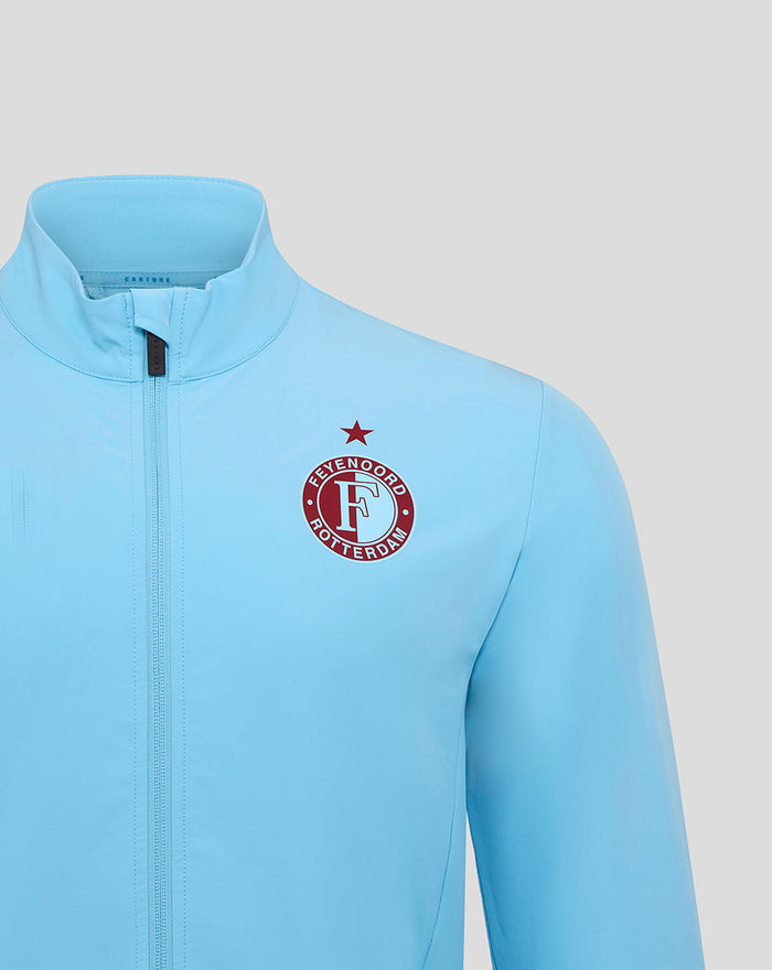 Front close up of a light blue Feyenoord third matchday jacket for men showing the Castore logo on the chest.