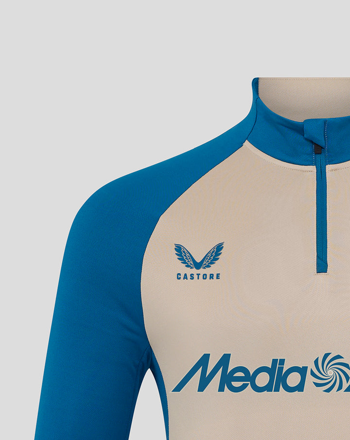 Close-up of front chest with Castore logo and large Media Markt sponsor across beige midlayer