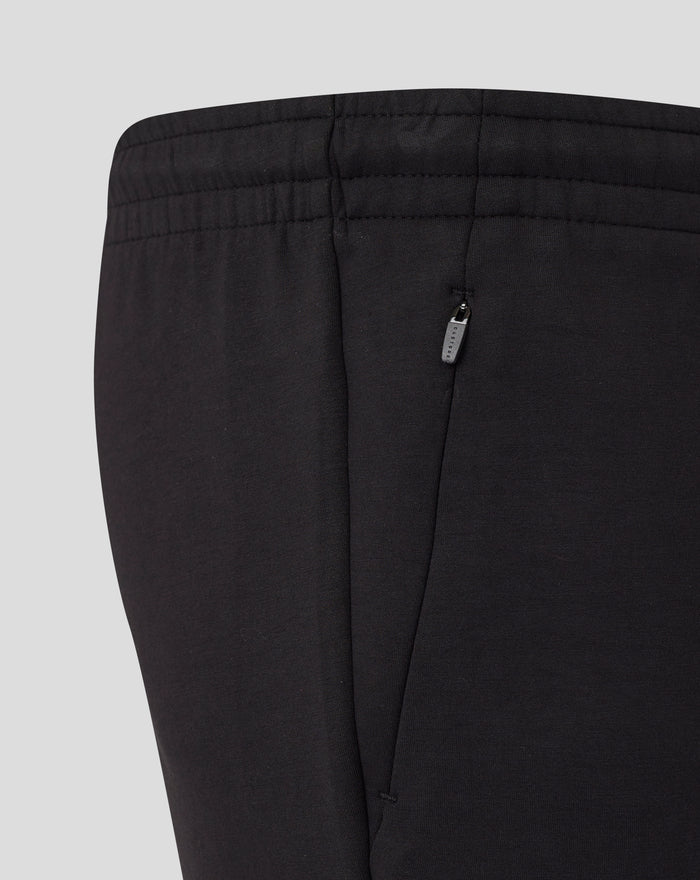 Back view of black shorts with elastic waistband and a small vertical zip pocket