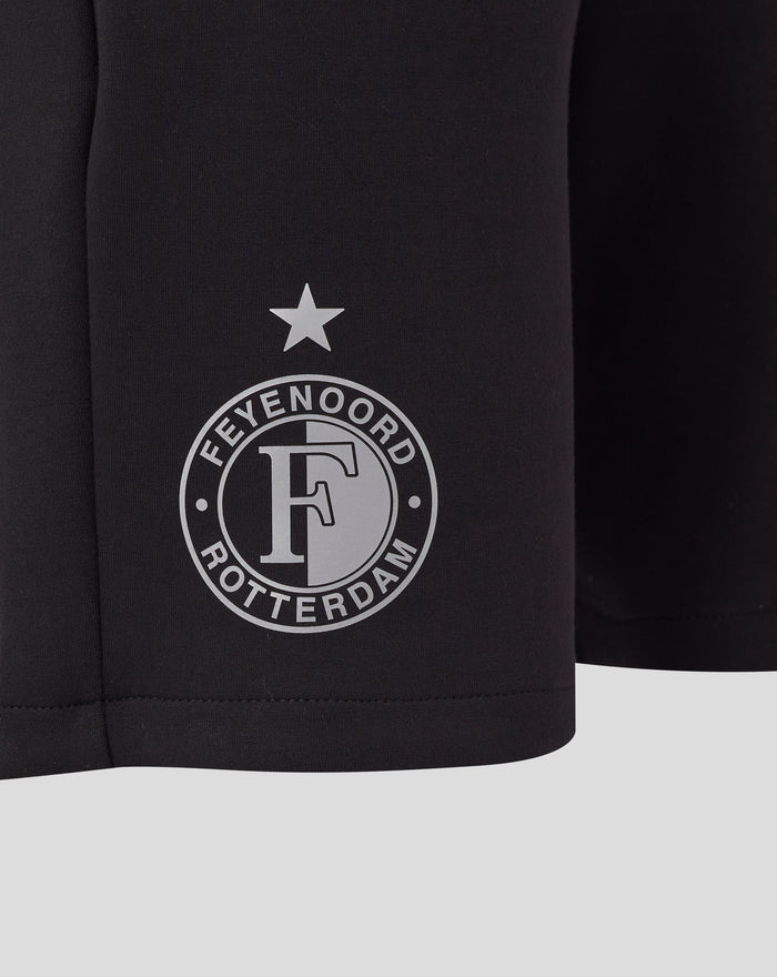 Close-up of black Feyenoord Travel Knit Short fabric featuring a white circular emblem with a star