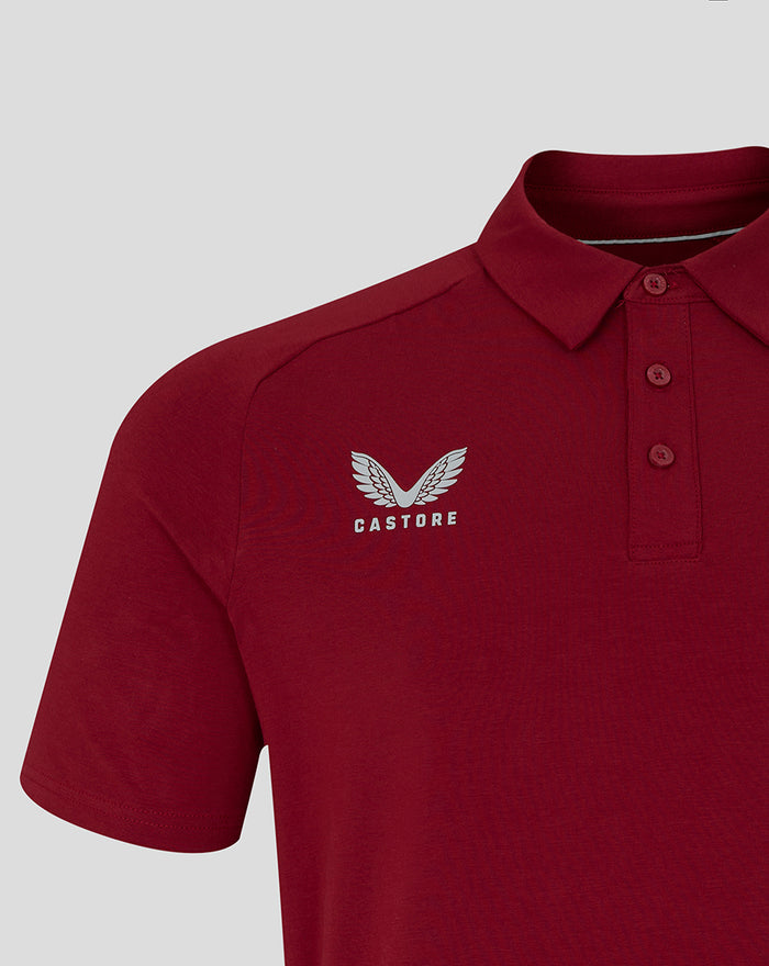 Close-up of a red polo displaying Castore branding on the left chest.