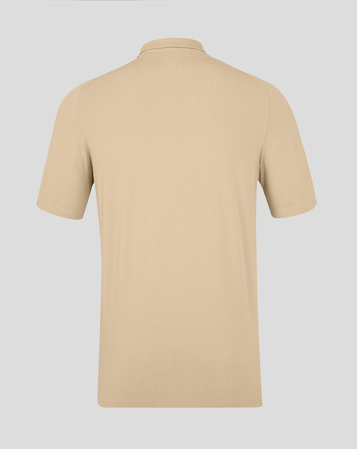 Back view of beige Feyenoord Travel Polo for men showing clean minimalist design and short sleeves