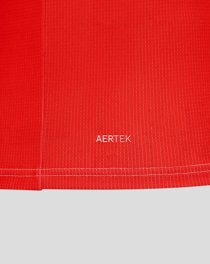 Close-up of the red jersey hem with white AERTEK branding