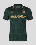 Front view of a green polo style Twaalfde Shirt with collar all over pattern club crest and gold Media Markt sponsor