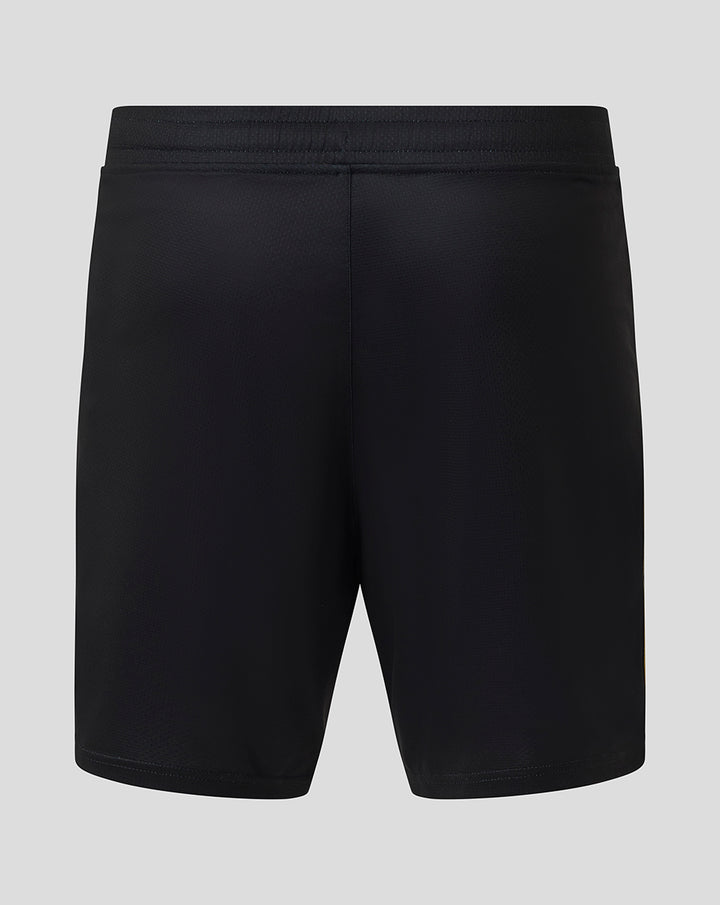 Back view of black junior shorts with elastic waistband showing Castore logo on the left leg and Feyenoord crest on the right leg