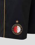 Close-up of the left leg bottom displaying the Feyenoord Rotterdam crest with a star above and the gold side stripe