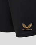 Close-up of black football shorts hem with gold Het Legioen wing embroidery