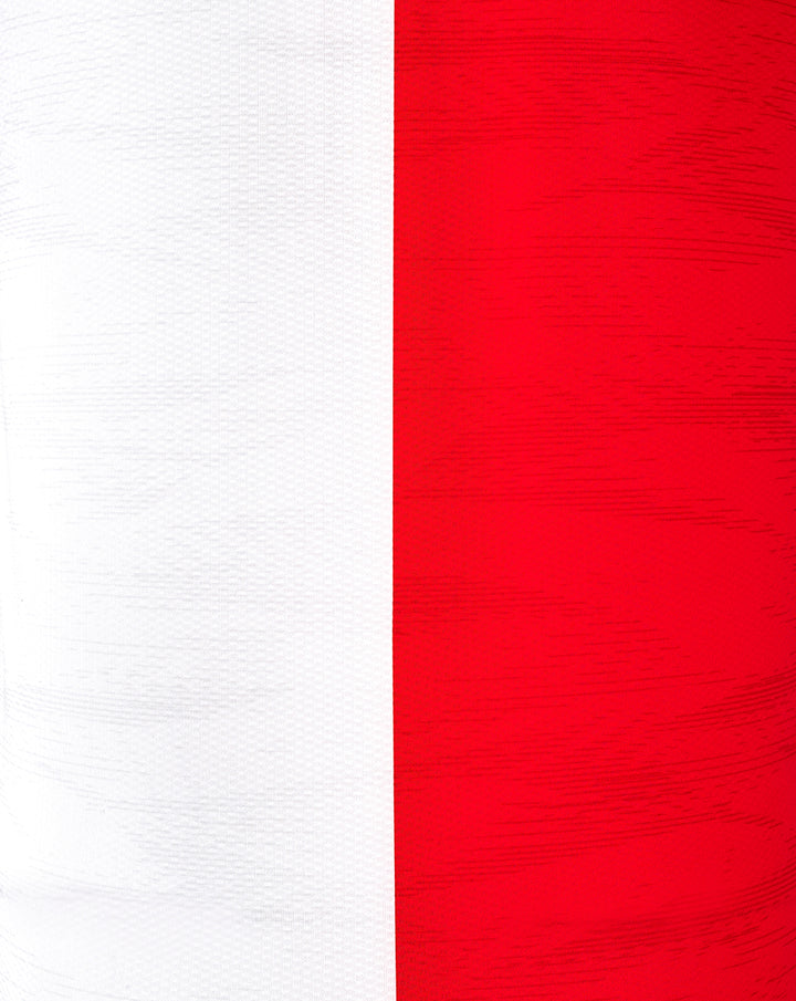 Close up of red jersey fabric with a vertical white panel and textured weave.