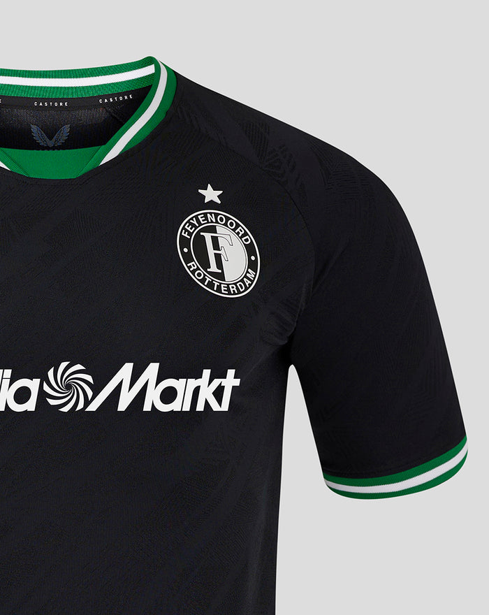 Close up of black Feyenoord Pro shirt with crest on left chest, MediaMarkt across front, and green striped collar.