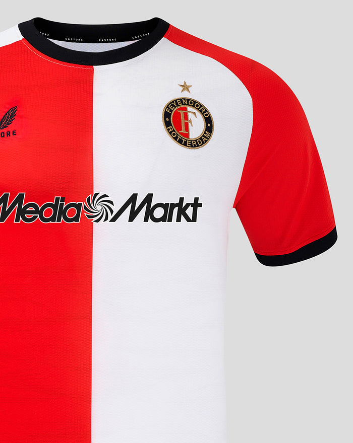 Close up of the Feyenoord home shirt front showing crest on the left chest and the MediaMarkt sponsor across the chest