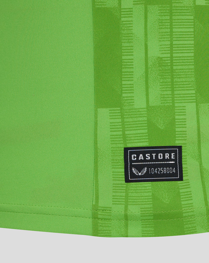 Close up of neon green fabric with a Castore patch on a Feyenoord keeper shirt